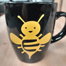 Image of a mug with a bumble bee graphic
